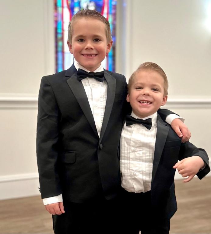 Coleman brothers smiling wearing tuxedos