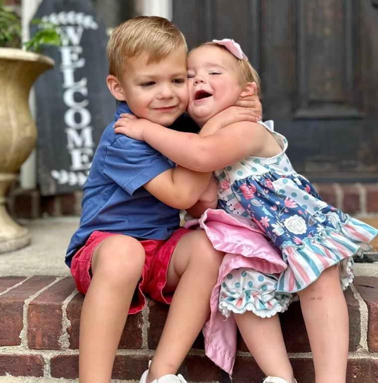 Coleman brother and sister hug each other