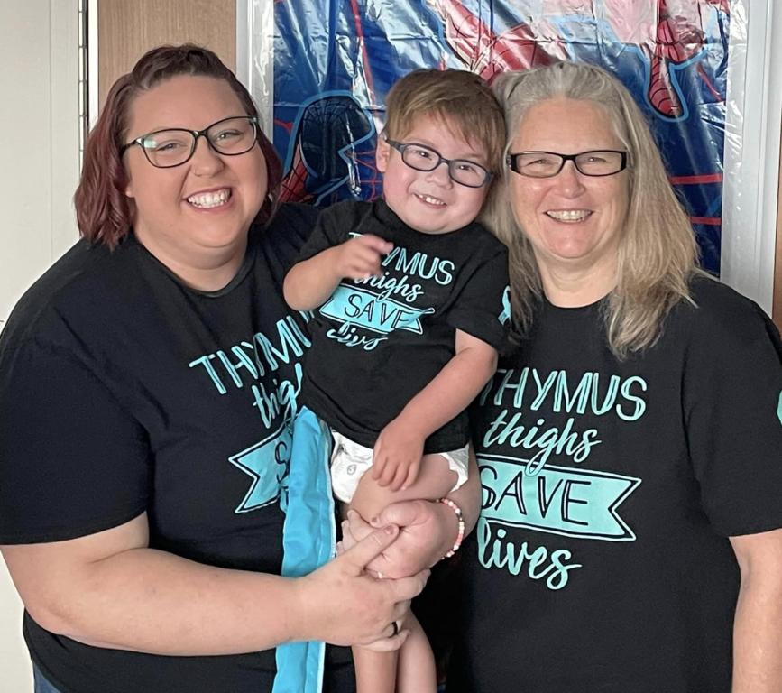 Young boy, mother and grandmother smiling