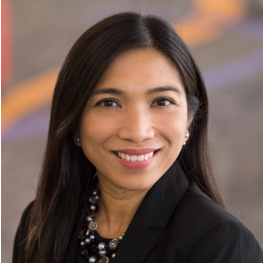 Female doctor with long brown hair smiling