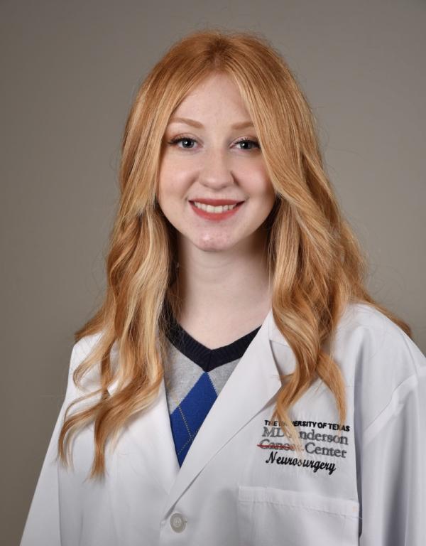 Scientist wearing lab coat smiles