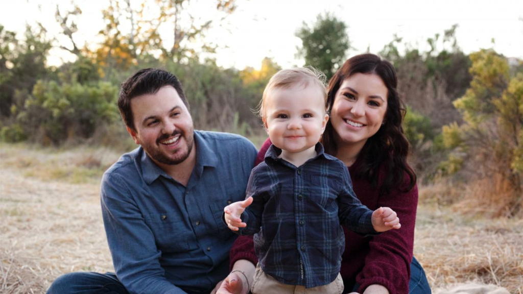 mom, dad, and baby photographed outside