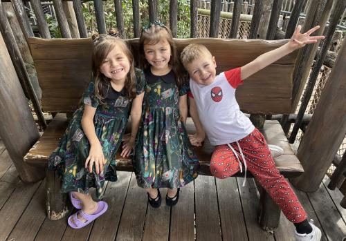 Langenhop kids sitting on a bench and smiling