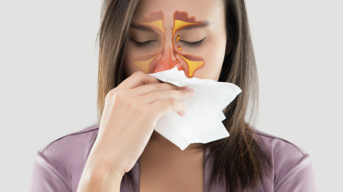 Woman blowing her nose