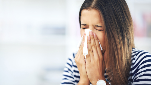 Woman blowing her nose