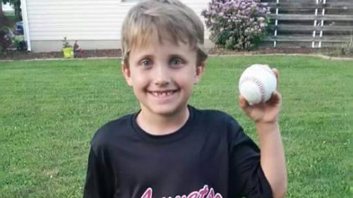 Thaddaeus Brown holds a baseball.