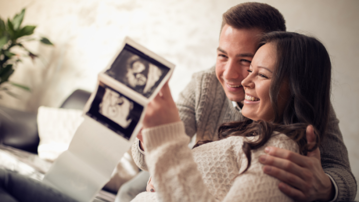 Couple smiling at pregnancy photos