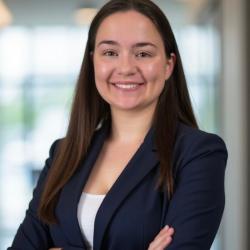 woman with brown hair in navy blue suit